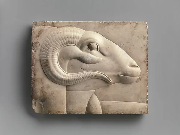 Relief plaque with the head of a ram deity